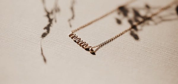 the story behind the mama script necklace