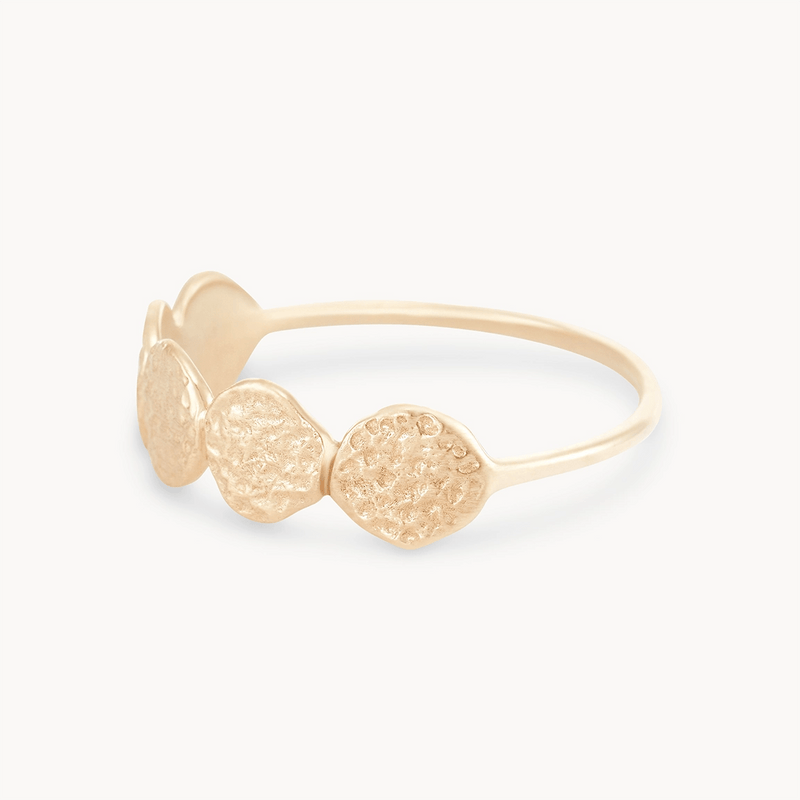 A bluboho abacus disk ring - 14k yellow gold featuring a delicate band and a design with three textured, circular discs at the front. The ring has a simple yet elegant appearance with a smooth, shiny finish.