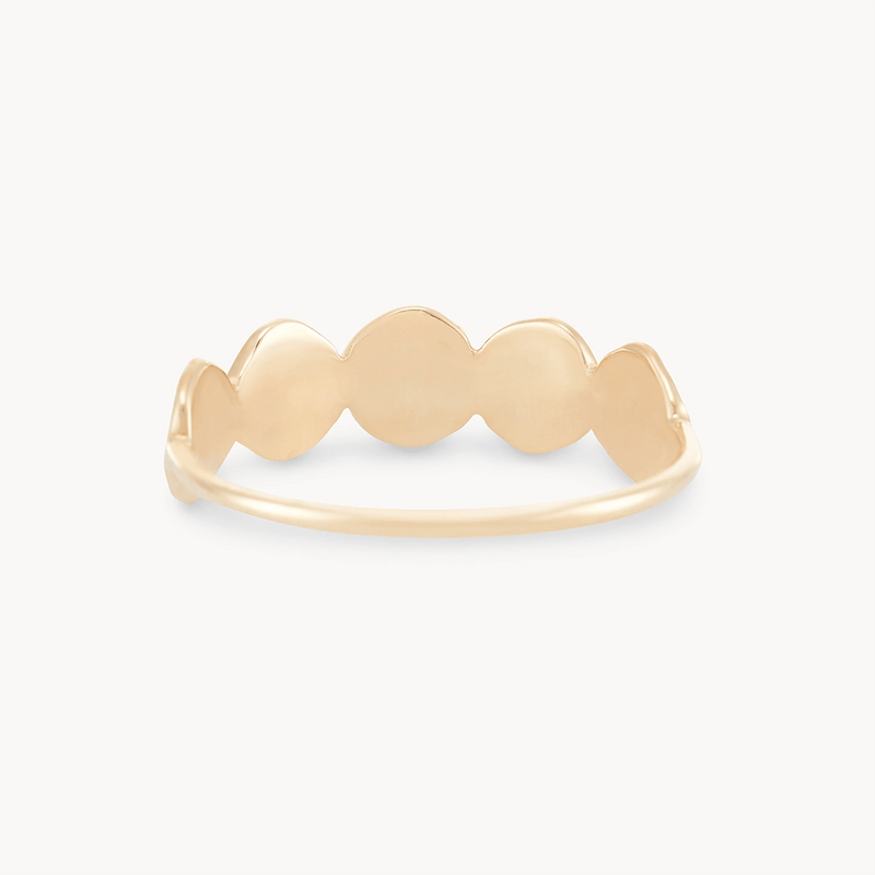 A gold ring with a thin band, featuring a cluster of interconnected round discs on the top. The design is simple and elegant, and the ring has a polished finish. This is the abacus disk ring - 14k yellow gold by bluboho.