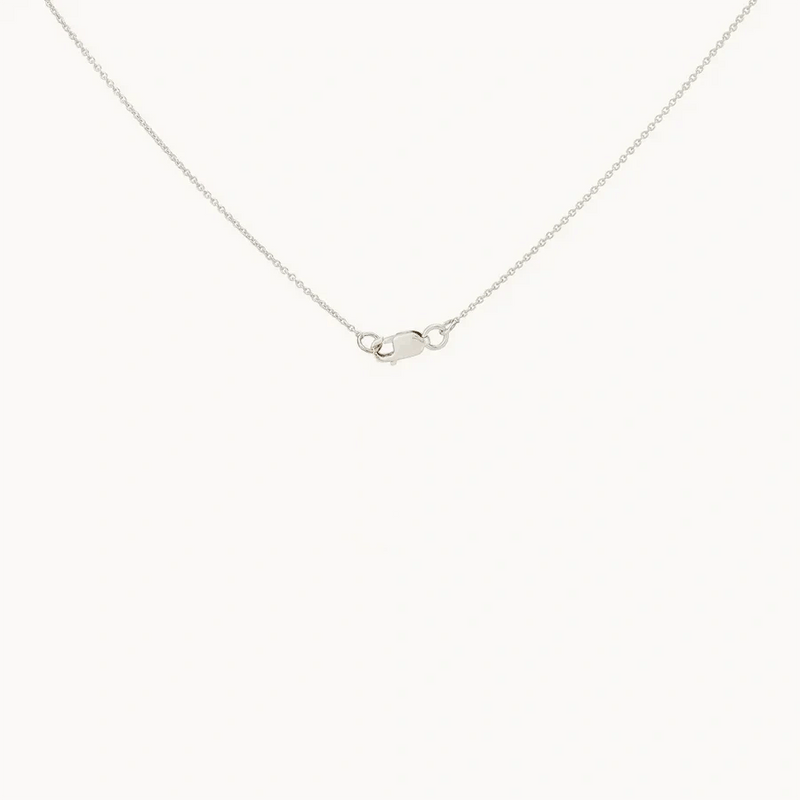 The dahlia flower necklace - sterling silver by bluboho is showcased on a plain white background. The delicate piece features a simple clasp at the center, highlighting its minimal and elegant design.