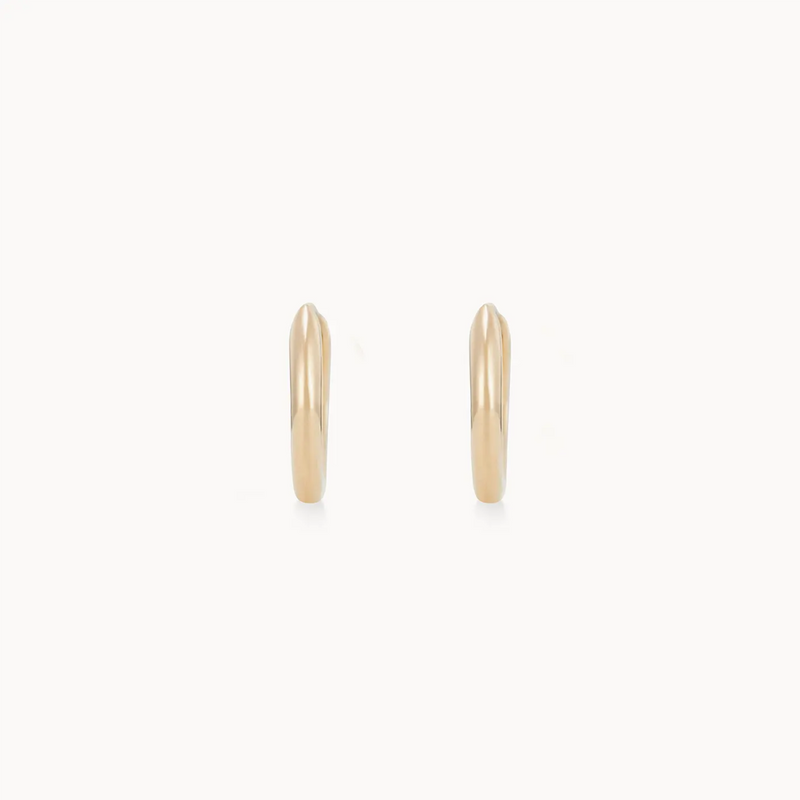 A pair of dagger small hoop earrings in 14k yellow gold, designed by bluboho, displayed against a white background. The earrings are simple and elegant, with a sleek design and no visible engravings or embellishments.