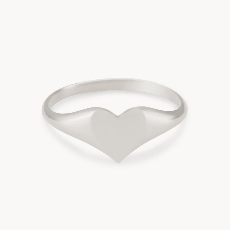 Introducing the lovely heart signet ring by bluboho - a sterling silver masterpiece showcasing a minimalist design with a smooth, heart-shaped centerpiece. The thin and sleek band enhances the elegant simplicity of the heart, elegantly displayed against a plain white background.