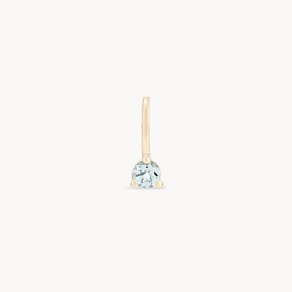 A single earring from bluboho's Serendipity March Birthstone Charm collection, crafted in 10k yellow gold with a simple, delicate hook design. It features a round aquamarine gemstone set at the base against a plain white background.