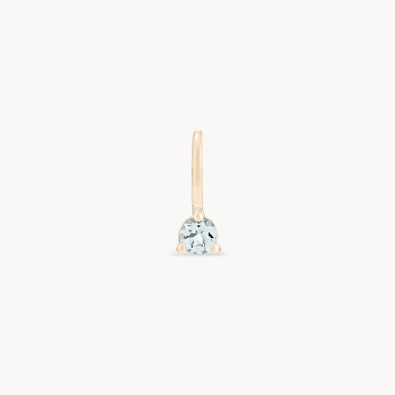 A single earring from bluboho's Serendipity March Birthstone Charm collection, crafted in 10k yellow gold with a simple, delicate hook design. It features a round aquamarine gemstone set at the base against a plain white background.