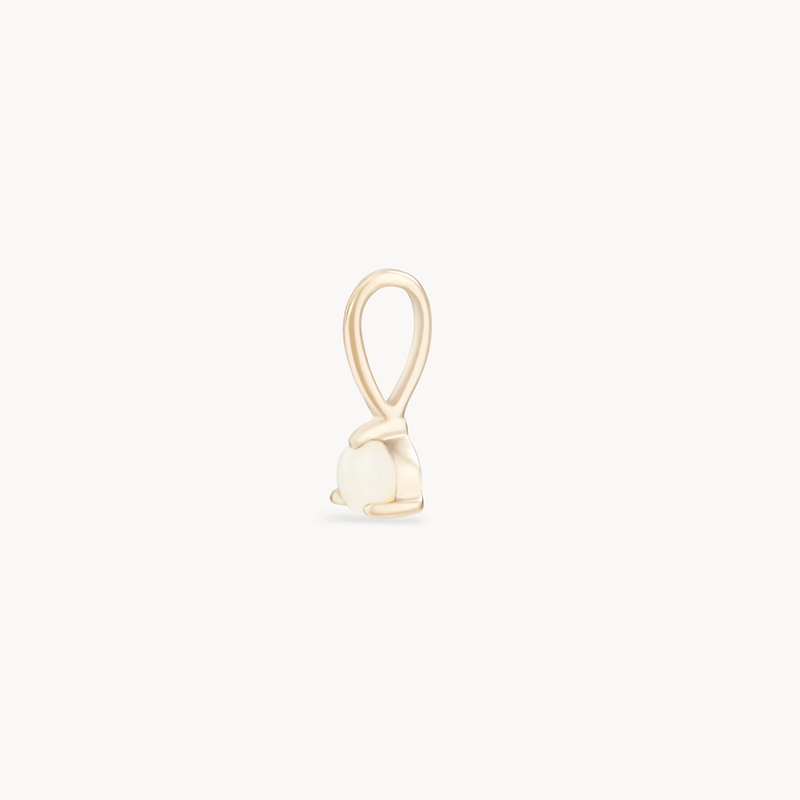 A small charm featuring a minimalistic geometric design. The charm is crafted from 10k yellow gold and features a loop at the top for attaching to a chain or bracelet. The lower part is adorned with an opal, accentuating its elegant form. This exquisite piece is the "serendipity october birthstone charm" by bluboho.