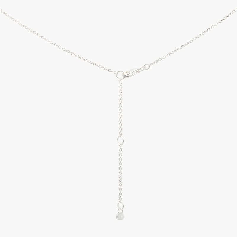 A delicate bluboho turquoise mood necklace silver - sterling silver, turquoise featuring a Y-shaped design with a small clasp at the top and a dangling chain end adorned with a tiny circular charm.