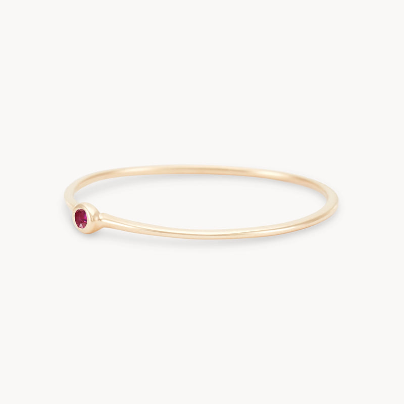 new bezel set serendipity ruby stacking ring - 10k yellow gold angled view