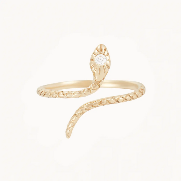 Introducing the "Serpent Revival Diamond Cuff Ring" by Bluboho: This 14k yellow gold ring showcases a snake design with intricate scale patterns and is crowned by a dazzling diamond set in its head, with the snake's body elegantly wrapping around to form the band.