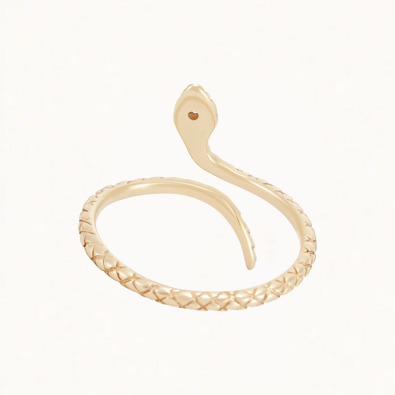 Introducing the Serpent Revival Diamond Cuff Ring by Bluboho – a stunning piece crafted in 14k yellow gold and adorned with diamonds. The ring features an intricate, textured, scale-like pattern along the band and showcases the head of the snake at one end and the tail at the other. This exquisite design creates a coil shape that wraps around your finger, mimicking a poised serpent ready to strike.