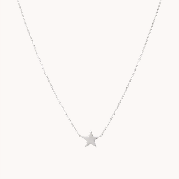 A delicate sterling silver necklace from bluboho, featuring a small, polished star-shaped pendant hanging at the center. The chain is thin and minimalist, accentuating the elegant and simple design of this stella star necklace silver. The background is plain white.