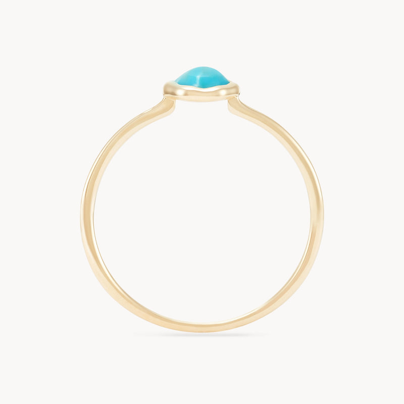 An elegant gold ring featuring a vibrant turquoise gemstone encased in a smooth, raised bezel setting, displayed against a plain white background. The turquoise mini mood ring - 10k yellow gold, turquoise by bluboho has a thin, smooth gold band.