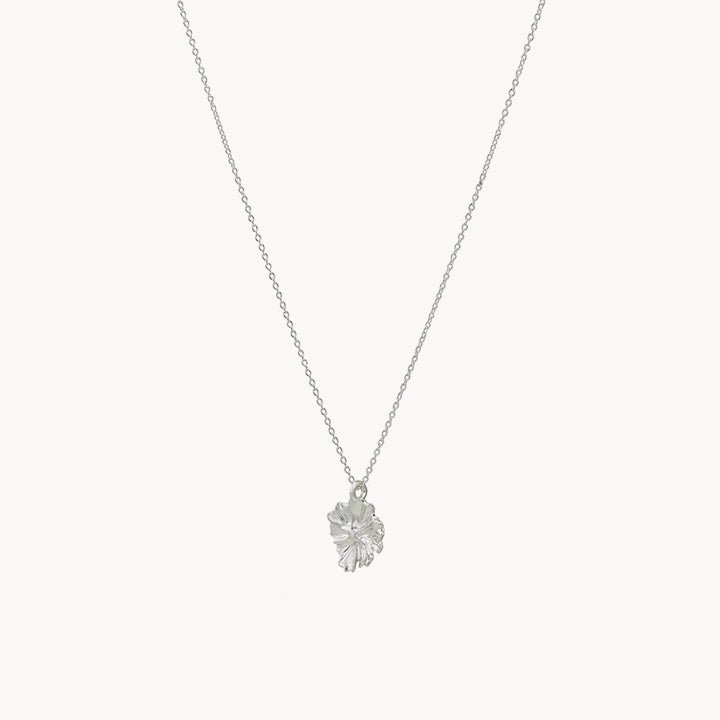 The larger wildflower necklace in sterling silver from bluboho showcases a small, intricately detailed leaf pendant hanging at the center of its fine chain. Set against a plain white background, this jewelry piece exudes simplicity and elegance.