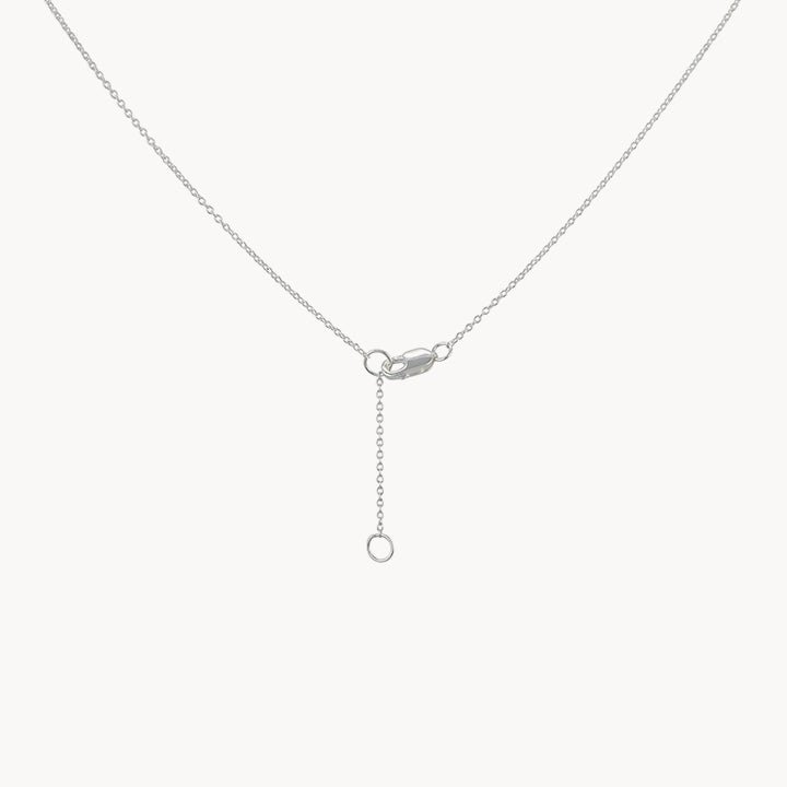 The larger wildflower necklace from bluboho features a delicate sterling silver chain with a small circular clasp and an adjustable extension chain. The extension chain culminates in a tiny circular loop, allowing for various length adjustments. The necklace is showcased against a plain white background.