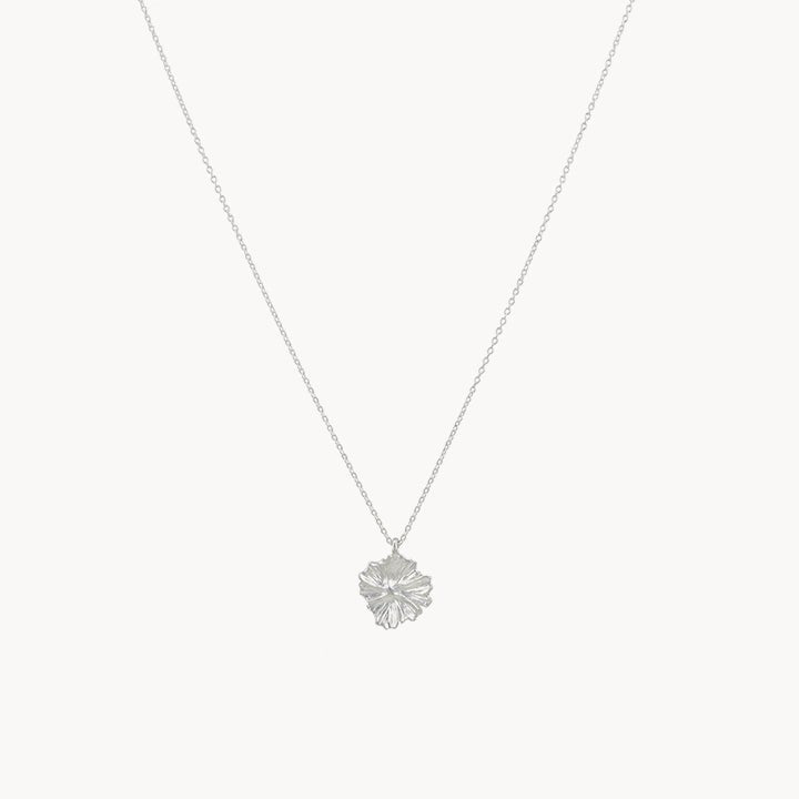 Presenting the larger wildflower necklace from bluboho in sterling silver, showcasing a thin chain coupled with an exquisitely detailed maple leaf pendant. The pendant boasts intricate veining and texture, infusing the minimalist design with natural elegance. This delicate piece is beautifully displayed on a plain white background.