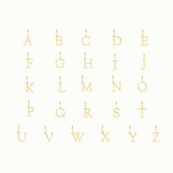 bluboho letter charm - 10k yellow gold displayed in five rows, with each row containing five letters from A to Z against a white background. The letters are capitalized and have small loops at the top for attaching to chains or bracelets.