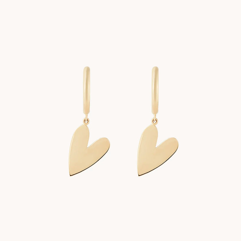 A pair of bluboho lovely heart sway hoop earrings in 14k yellow gold, featuring heart-shaped pendants with a sleek, minimalist design, set against a plain white background.