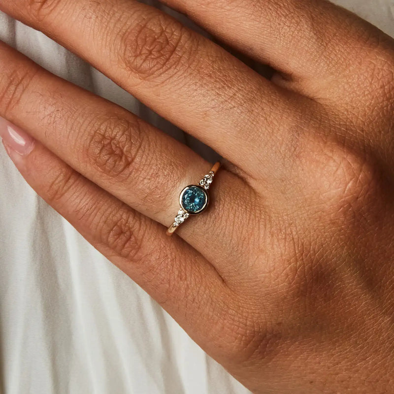 true blu one-of-a-kind engagement ring - 14k yellow gold, light royal blue round sapphire in person